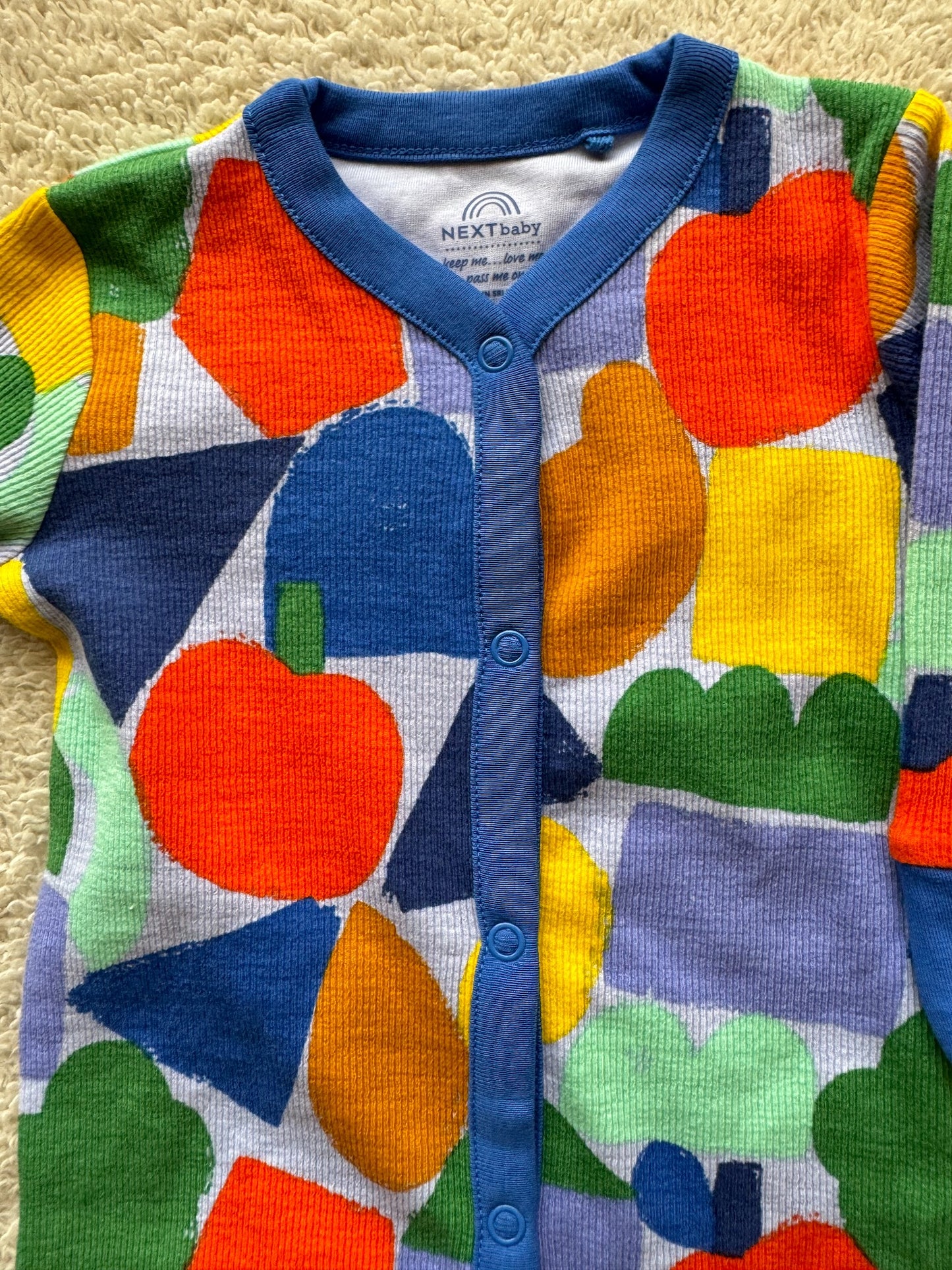 Jumper - Multi coloured shapes on blue